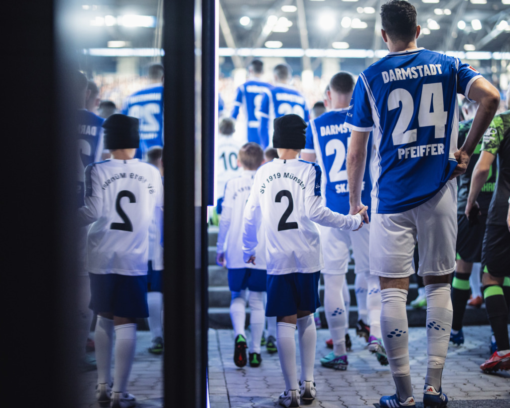 Players of both teams walk out of the tunnel during the Bundesliga match between SV Darmstadt 98 and VfL Wolfsburg